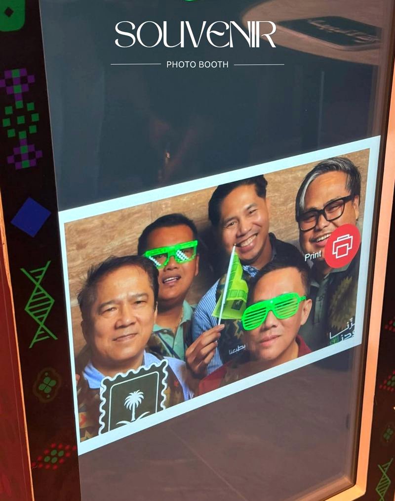 Group of guests with fun glasses on the booth screen