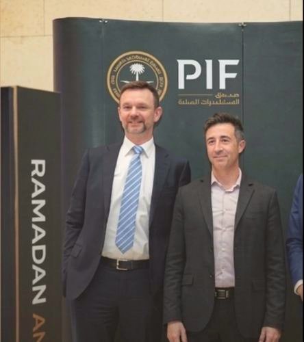 Guests posing in front of a branded event backdrop